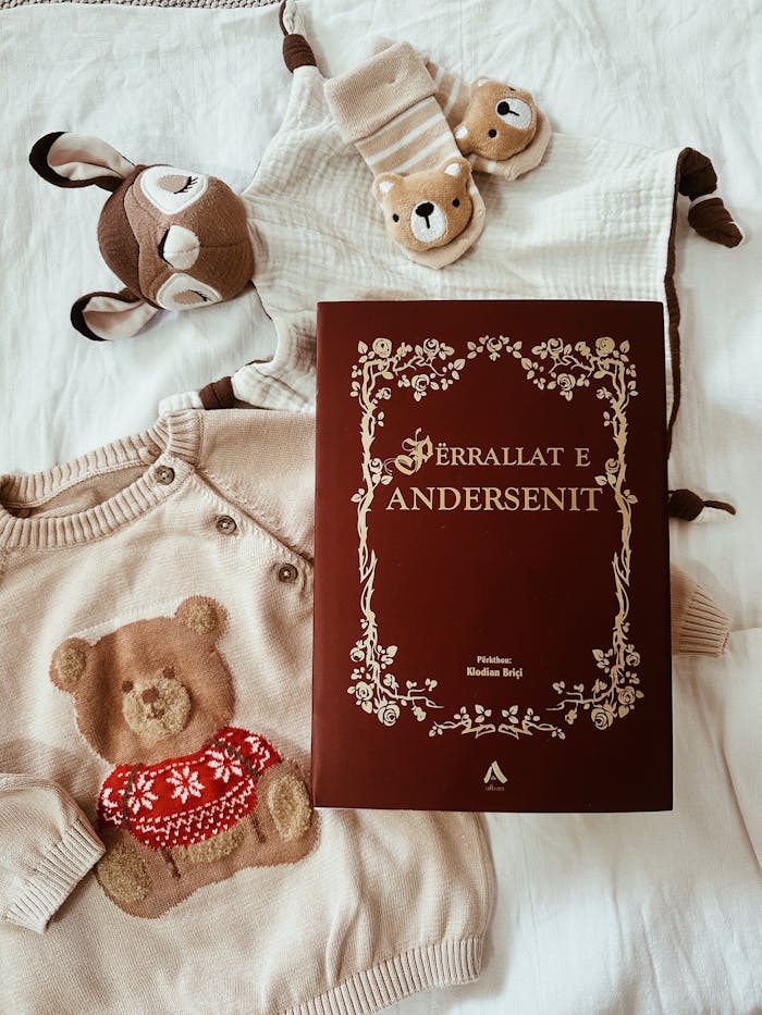 Flat lay of baby clothes with a storybook, perfect for nursery decor.
